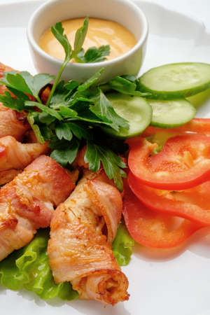 Meat rolls on a white background with cucumbers and tomatoes.の写真素材