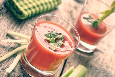 Tasty tomato juice on a wooden table.の写真素材