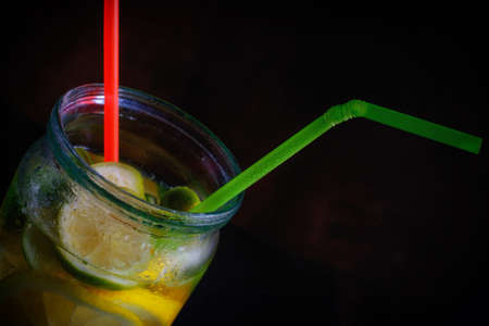 detox water with a lemon, lime and mint on a wooden tableの写真素材