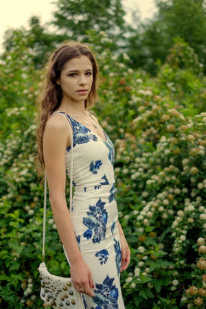 Outdoors portrait of beautiful young brunette girl.