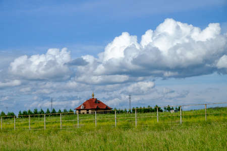 Church in a beautiful field. Siberia, Russiaの写真素材