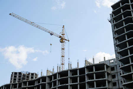 Construction site with cranes on sky backgroundの写真素材