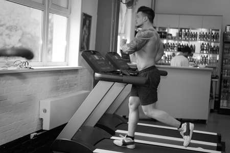 young man is engaged in bodybuilding at the gymの写真素材