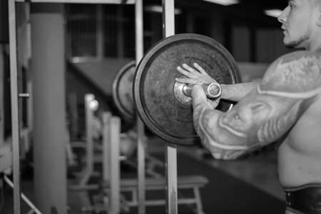 young man is engaged in bodybuilding at the gymの写真素材