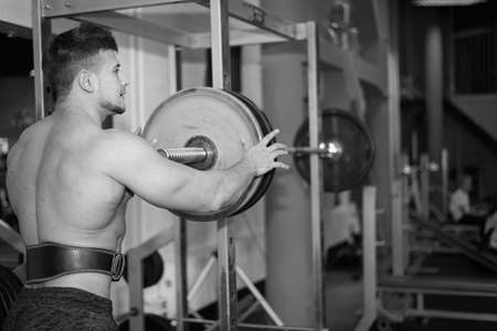 young man is engaged in bodybuilding at the gymの写真素材