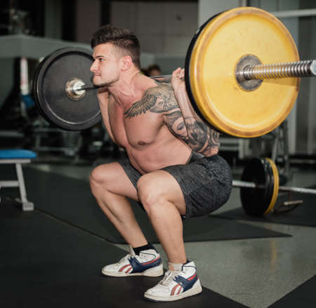 young man is engaged in bodybuilding at the gymの写真素材