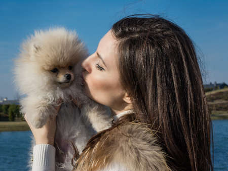 Young woman kissing her dogの写真素材