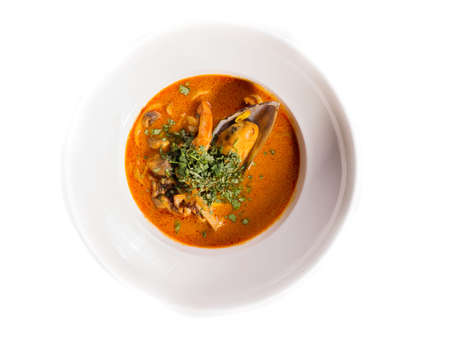 cream soup with popcorn, arugula on white background