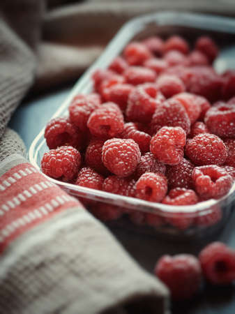 Fresh raspberries in a disposable plate