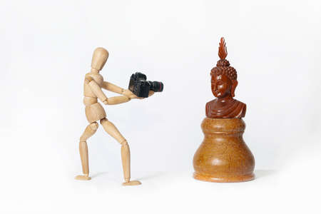 Wooden mannequin, on a white background. Photographer.の写真素材