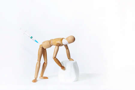 Wooden mannequins, on a white background. Vaccination.