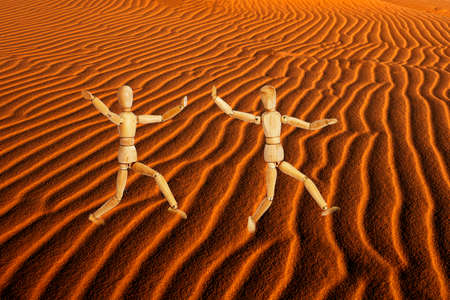 Wooden mannequins in the desert. 3d renderingの写真素材