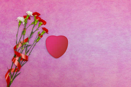 Pink background with a heart for congratulations and declarations of love. Concept for Valentines...