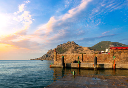 Beautiful view of the sea and mountain at sunsetの写真素材