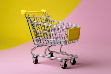 Shopping cart on pink and yellow background. Minimal style.の素材
