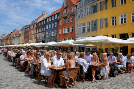 People visit Nyhavn in Copenhagen, Denmarkの素材