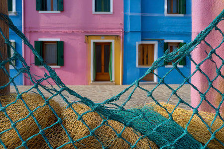 Fishing nets in front of a colorful house in Burano island, Venice, Italyの素材