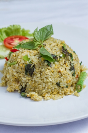 close up fried rice with green curry with chicken, Thai food on white dishの写真素材