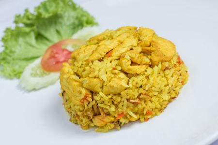 close up fried rice with yellow ginger with chicken, Thai food on white dishの写真素材
