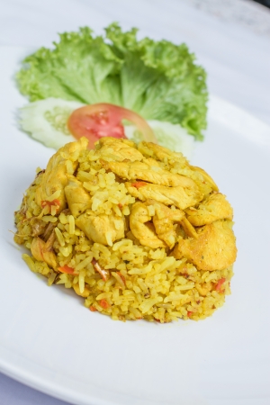 close up fried rice with yellow ginger with chicken, Thai food on white dishの写真素材