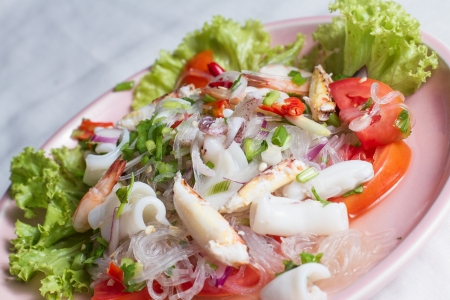 cellophane noodle Spicy salad with seafood on pink plateの写真素材