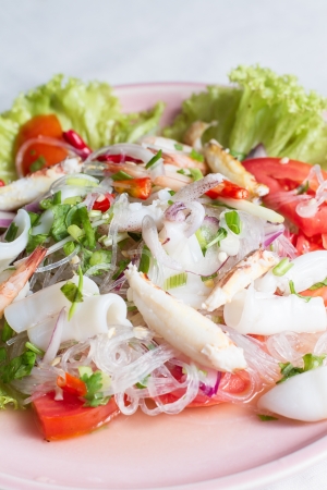 cellophane noodle Spicy salad with seafood on pink plateの写真素材