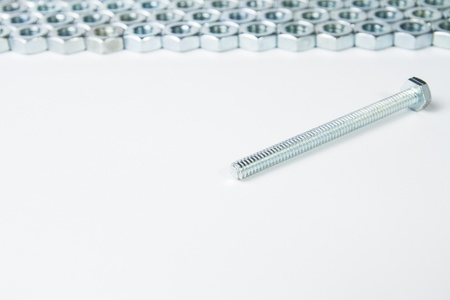 Chrome nuts and bolts closeup on plain backgroundの写真素材