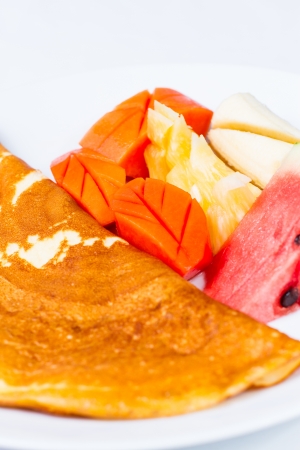 Crepe with mix fruit on white plateの写真素材