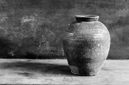 Dark jar on woodの写真素材