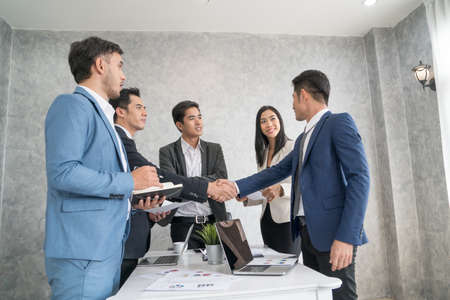 Businessman checking hand to success deal and agreement while another people applauding. Concept for...