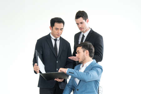 Business men pointing at report in laptop to discuss about strategy. Brainstorming, Concept for Work, Meeting, Presentation, Coaching on white backgroundの写真素材
