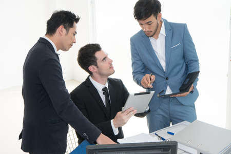 Business men pointing at report in tablet to discuss about strategy. Brainstorming, Concept for...