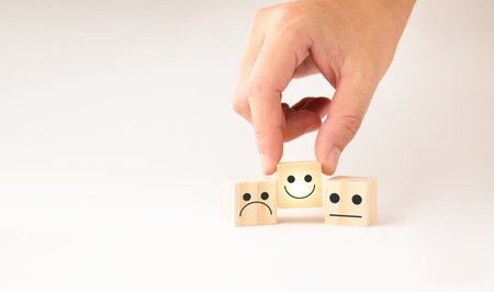 Customer service and Satisfaction concept ,Business people show a feedback with smile face wood cube...