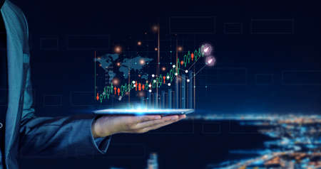 Businessman planning to invest in stock market. man touching success goals icon on virtual screen, stock graph is rising, economy is recovering, stock trading, bussiness start up, business success.の写真素材