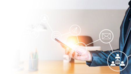 Business contact concept. Businessman using smart phone to contact business network, customer service. Contact us via Call, Messaging, Internet, Email, Hotline, Private Message. wireless connection.の写真素材