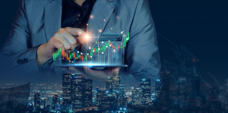Businessman planning to invest in stock market. man touching success goals icon on virtual screen, stock graph is rising, economy is recovering, stock trading, bussiness start up, business success.の写真素材
