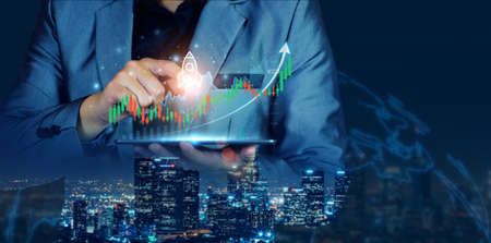 Businessman planning to invest in stock market. man touching success goals icon on virtual screen, stock graph is rising, economy is recovering, stock trading, bussiness start up, business success.の写真素材