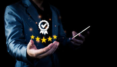 The concept of providing a five-star premium service. businessman showing award High standards are guaranteed, service quality, business success, work efficiency, top quality assurance 5 stars.の写真素材