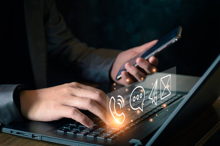 Concept of business communication. Businessman using computer and smartphone to contact customers via online internet, meeting, global network, shape icon phone email mail message on virtual screen.の写真素材