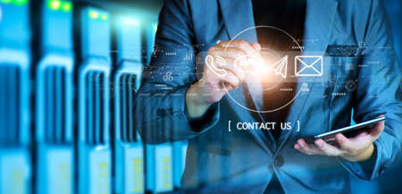 Concept Contact us or connected customer support hotline. businessman touching icon to communicate on a virtual screen,through a digital, global network. Icon (Email,Live Chat,Internet,Phone, Message)の写真素材