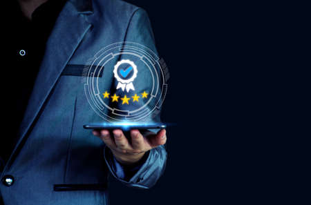 The concept of providing a five-star premium service. businessman showing award High standards are...