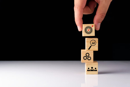 Business success goals Concept. Business man planning business operations. set business goals, use wooden blocks to plan, set goals for future success, use wooden blocks to create ideas, set target.の写真素材