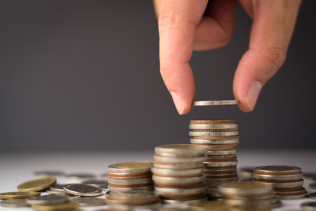 Business man putting coins Business growth and investment chart, strategic planning to increase profits from doing business, long-term investment planning, save money for future inの写真素材