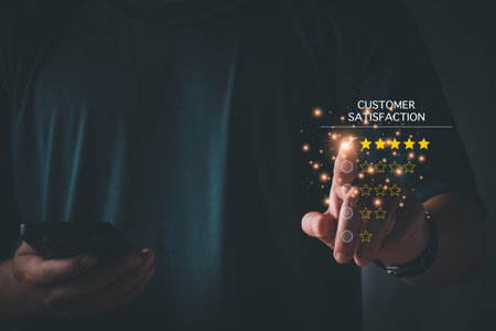 Customer satisfaction assessment concept, man using smartphone smiling and thumbs up, rate five stars, send smiley emoji and hearts, satisfied smiley face, excellent service, customer be happy.の写真素材