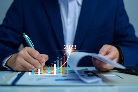 Businessman analysis profitability of working companies with digital augmented reality graphics, positive indicators in 2023, businessman calculates financial data for long term investments.の写真素材