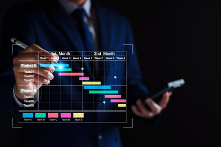 Project manager working on tablet and updating tasks and milestones progress planning with Gantt...