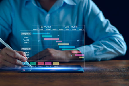 Project manager working on tablet and updating tasks and milestones progress planning with Gantt chart scheduling interface for company on virtual screen. Business Project Management System.の写真素材