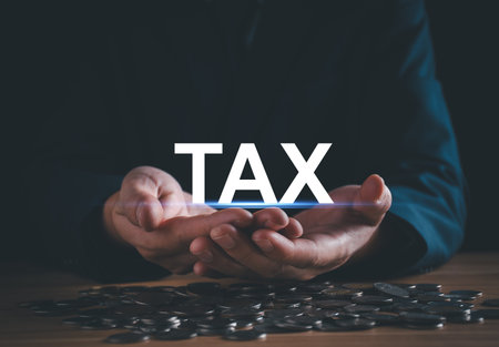 Tax and vat concept. Businessman holding Tax icon. Calculate money income to pay taxes and vat according to law. Calculator calculates refund from tax deduction. Business and financial service.の写真素材