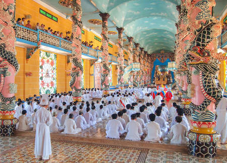 TAY NINH, VIETNAM - MARCH 3, Meditating followers of the Cao Dai religion in the temple Cao Dai on MARCH 3, 2013のeditorial素材