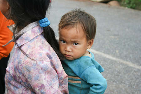 XIENG KHOUANG , LAOS - JUNE 16 : Laotian Hmong children in a village by the road near Xieng Khouang Province on 16 June 2005のeditorial素材